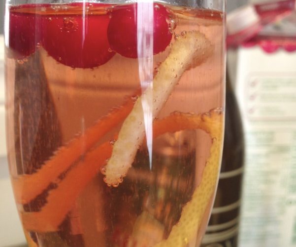 A sparkling wine, cranberry juice, and ginger ale holiday cocktail.