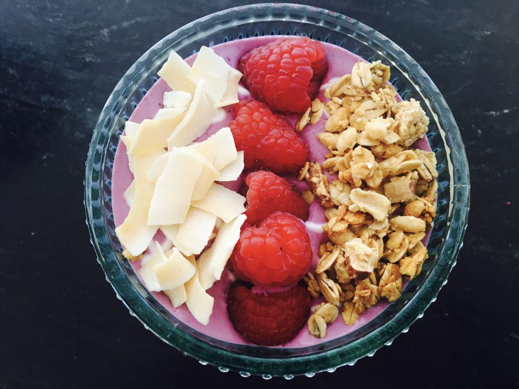 Smoothie Bowl with Coconut Chips, Granola and Raspberries