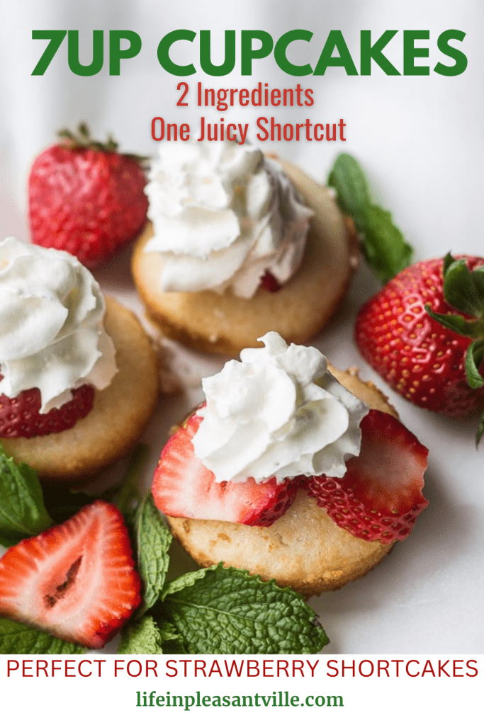 Three golden 7UP cupcakes topped with whipped cream and fresh strawberries, styled with mint leaves on a white surface.