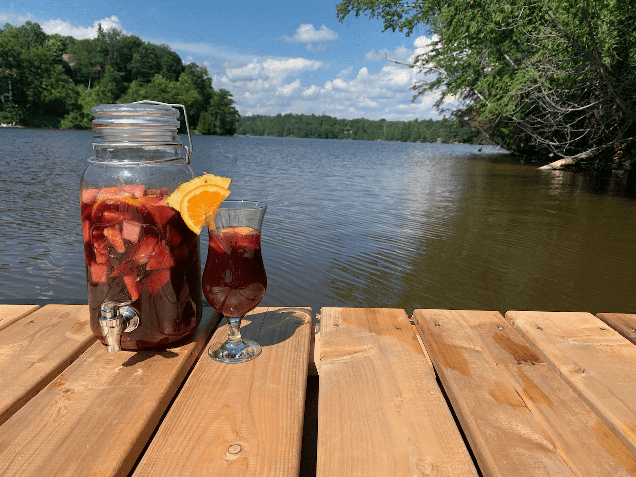 Boozy sangria in a glass pitcher with fresh fruit