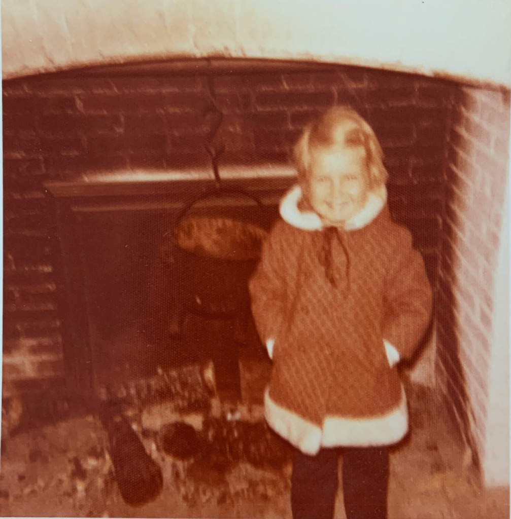 A child standing in front of a fireplace at the Fortress of Louisbourg in 1973