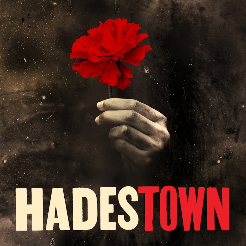 The iconic Hadestown poster, a warning and a promise tucked into one red flower.