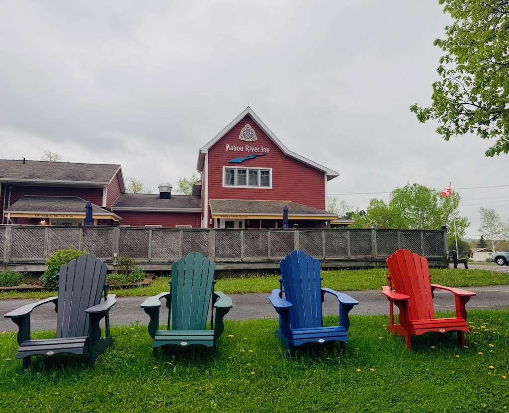Mabou River Inn exterior with colourful Adirondack chairs in Mabou Cape Breton, where to stay celtic colours