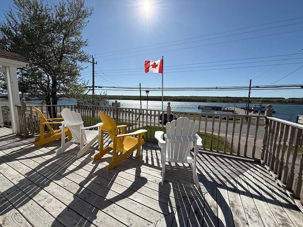Waterfront deck at Archie and Isadore hotel in Chéticamp with views over the bay