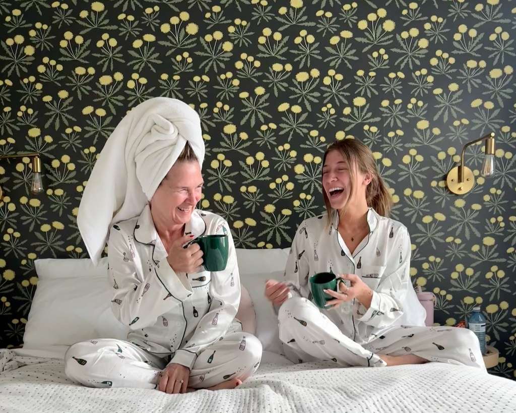 Candace and her daughter laughing over morning coffee at Archie and Isadore hotel in Chéticamp Cape Breton