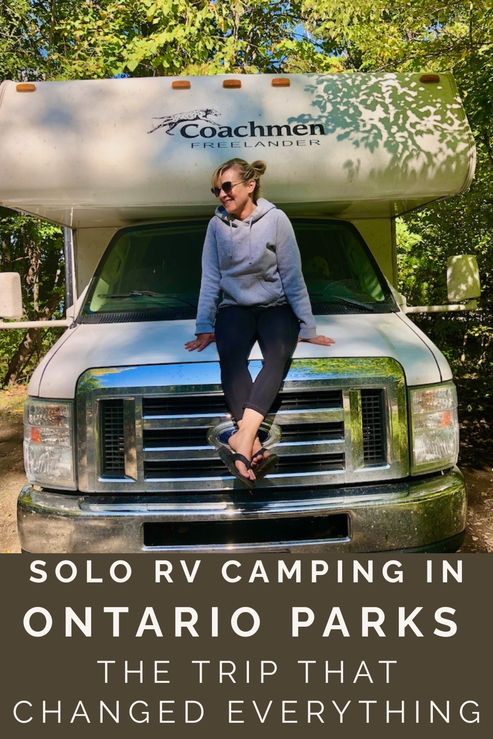 Woman sits on a rented RV in Ontario Parks during a solo camping trip, representing confidence, independence, and outdoor adventure in Canada.