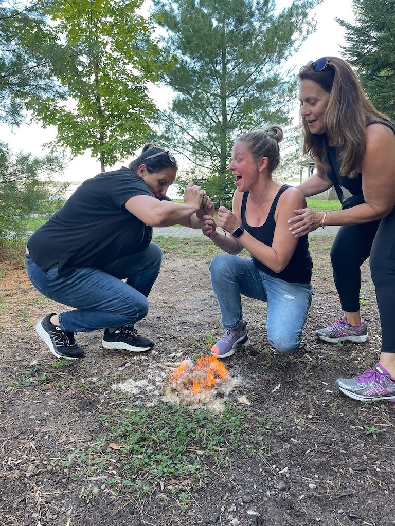 Women learning how to make fire at Beausoleil Island