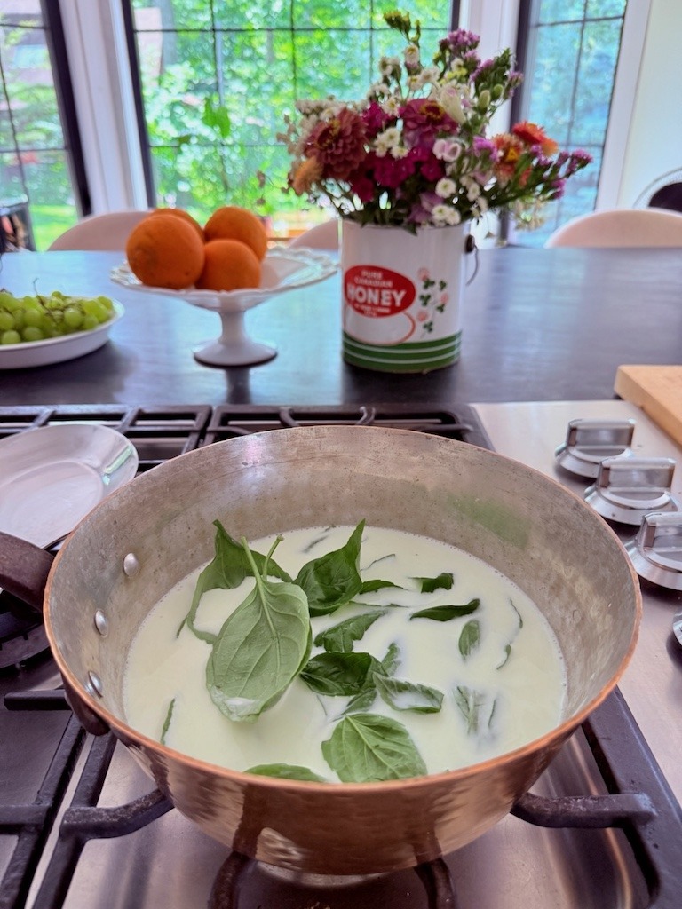 Fresh basil infusing the custard base of homemade Strawberry Basil ice cream.