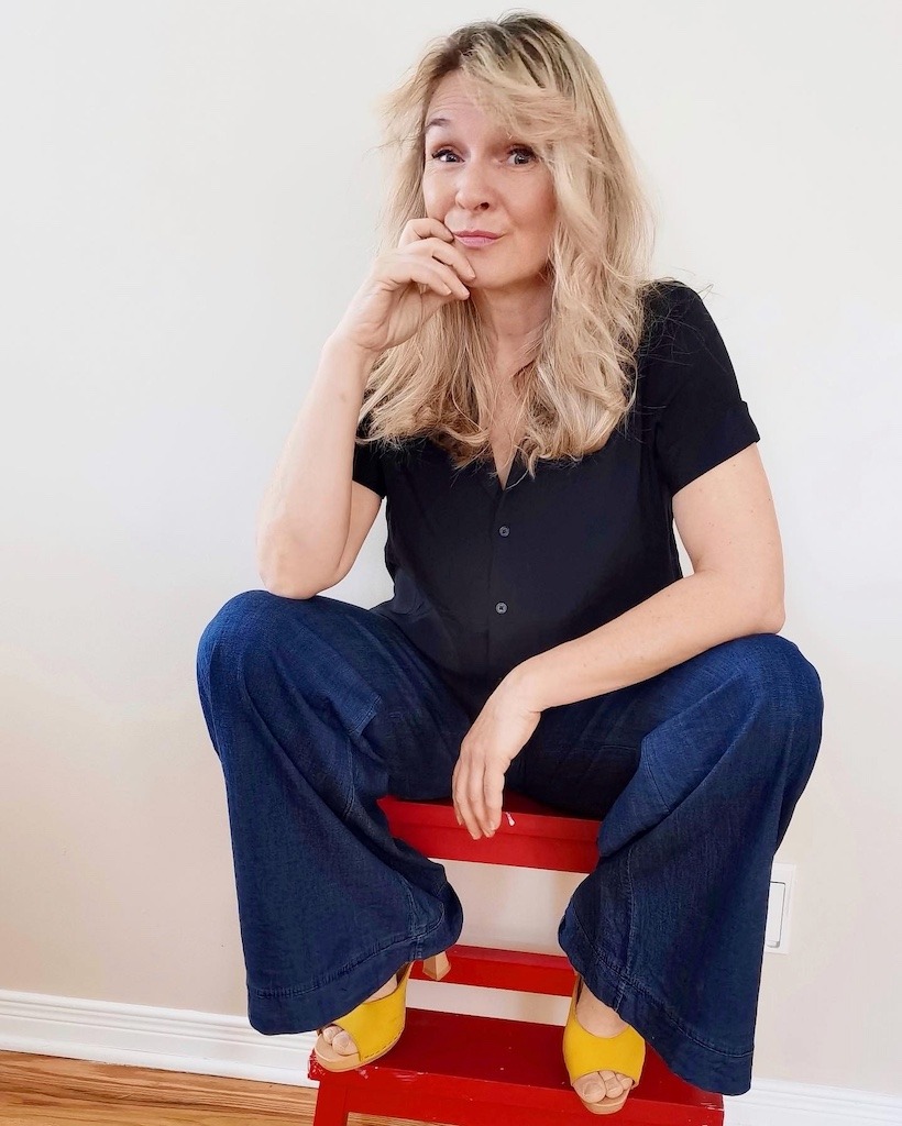 Gen X woman sitting with a knowing look, done with the bullshit, ready to speak her mind