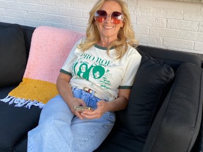 Gen X woman smiling in a Pro Roe t-shirt, done being angry and choosing joy instead