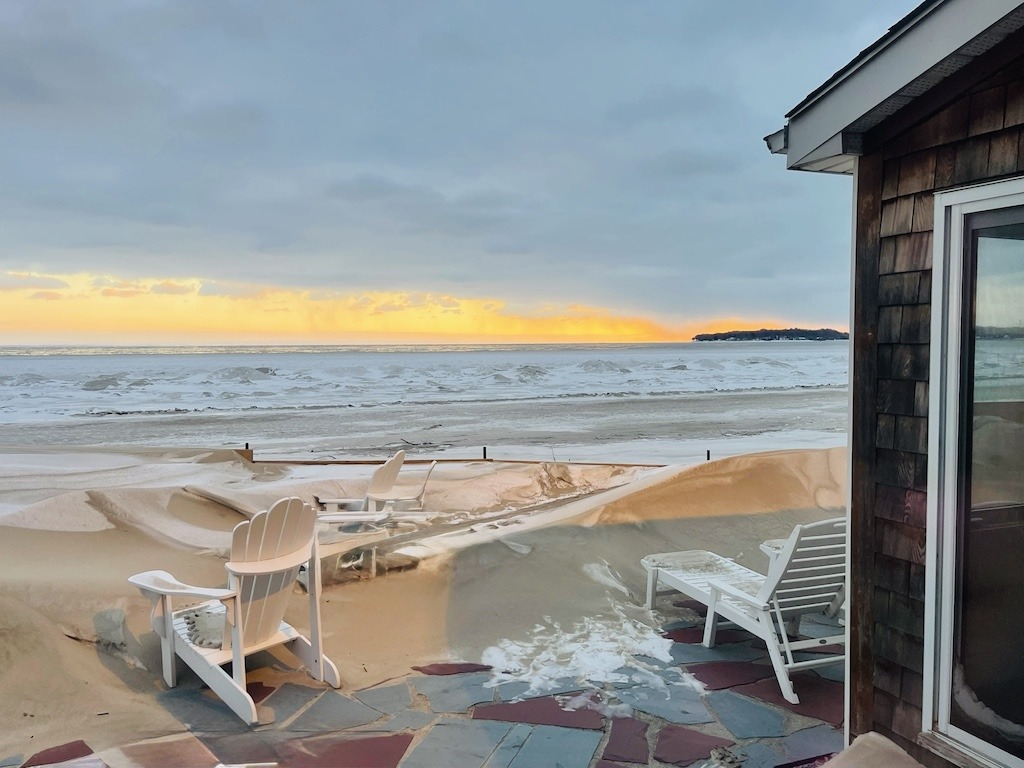 Snow-covered patio chairs overlooking Lake Erie during Crystal Beach Ontario winter sunset