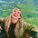 a feature image for an article about extinction of experience where a woman is experiencing pure joy in a hot air balloon