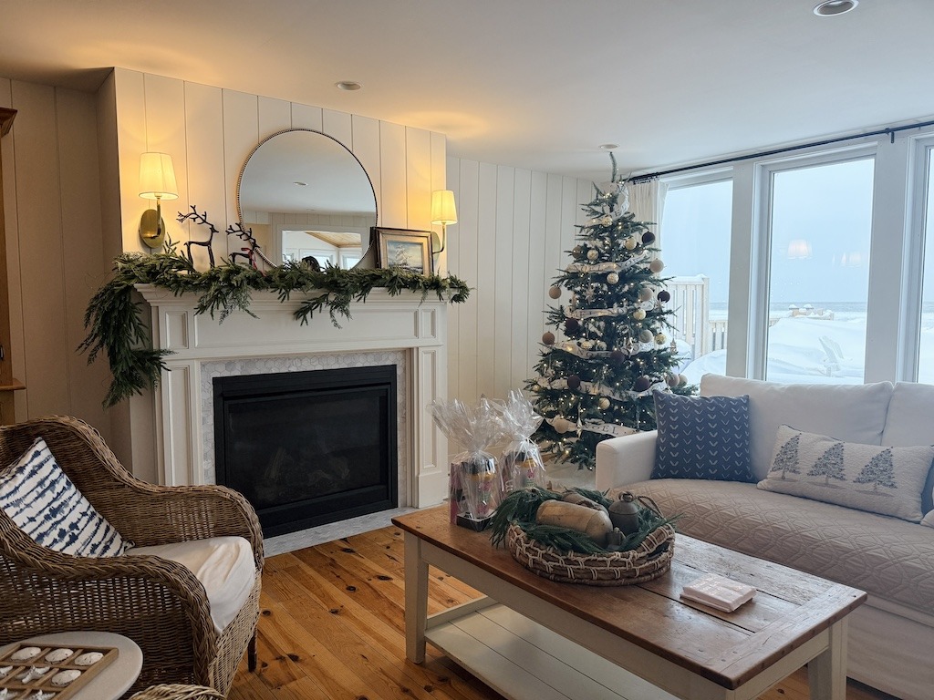 Cozy living room with fireplace and Christmas tree inside a rental home
