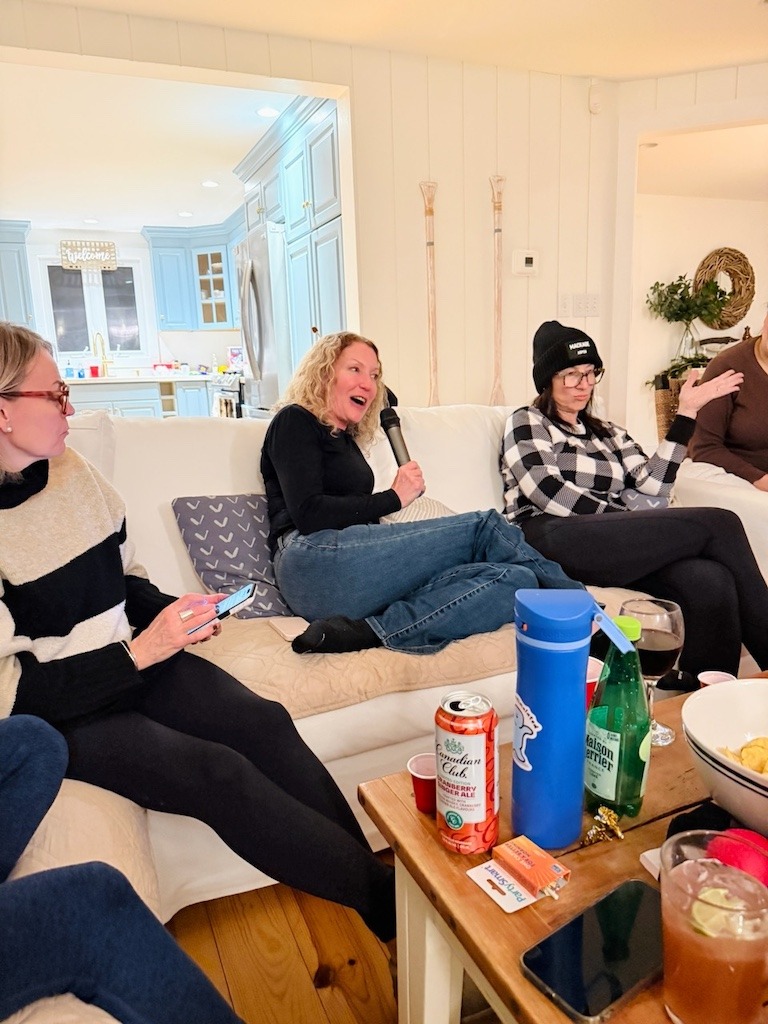 Friends playing Never Have I Ever inside rental home