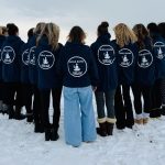 Girls Gone Mild group wearing matching navy hoodies on snowy Crystal Beach Ontario in winter