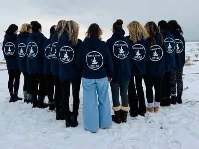 Girls Gone Mild group wearing matching navy hoodies on snowy Crystal Beach Ontario in winter