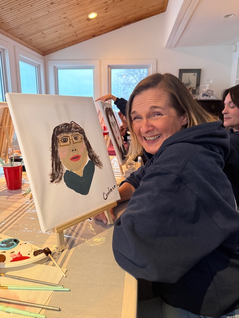 Woman painting a portrait during a Crystal Beach Ontario winter girls weekend activity