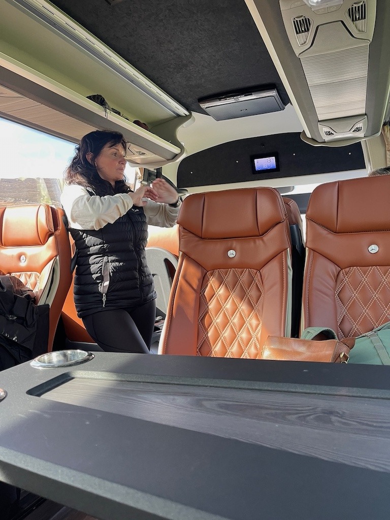 Tour guide Dee Morgan on board a luxury coach on the Wild Atlantic Way, Ireland