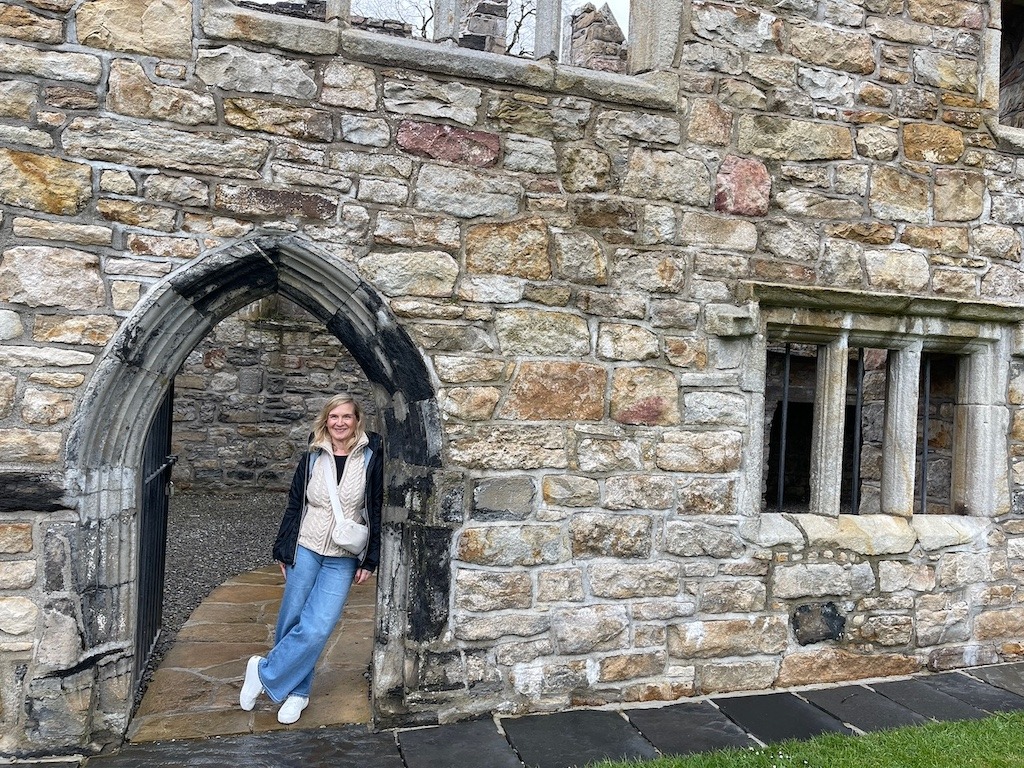 Gothic archway entrance of Donegal Castle, a 15th century fortress built by the O'Donnell clan in Donegal Town, Ireland. Dongal is easily accessible on this Ireland road trip itinerary.