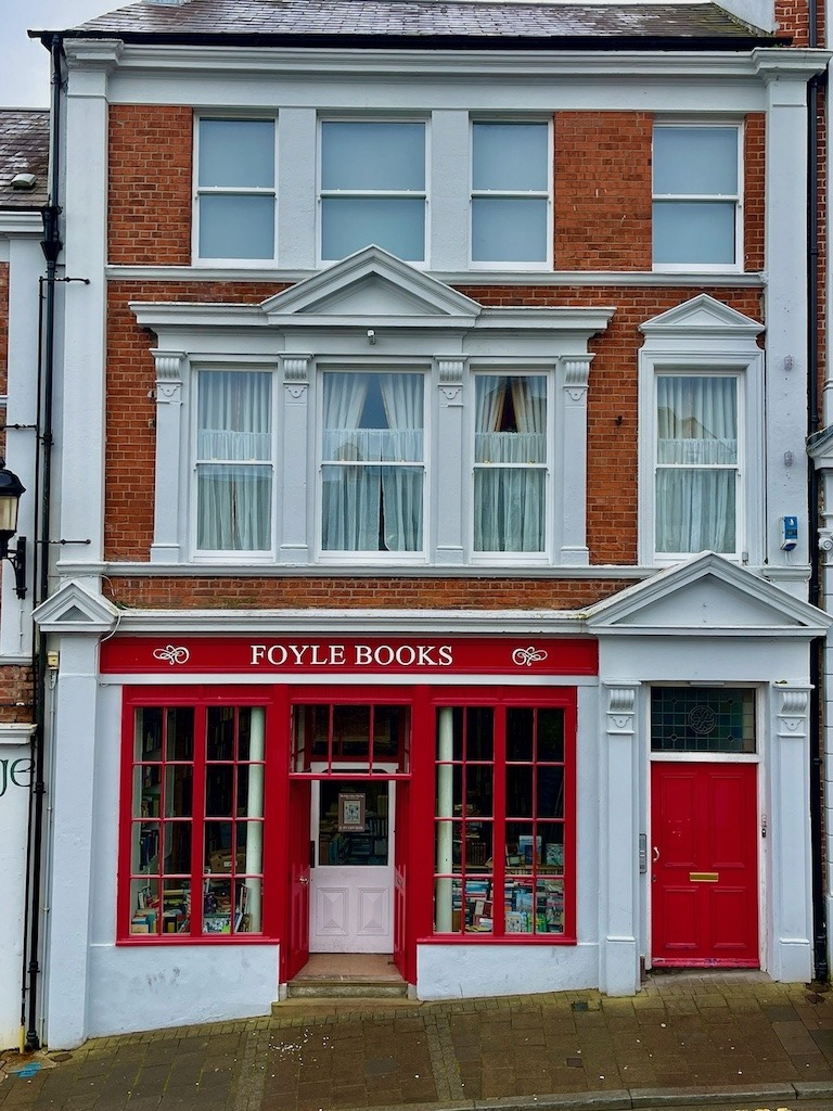 Foyle Books, a charming independent bookshop with a bright red Victorian shopfront in Derry, Northern Ireland. A perfect stop on your Ireland road trip itinerary.