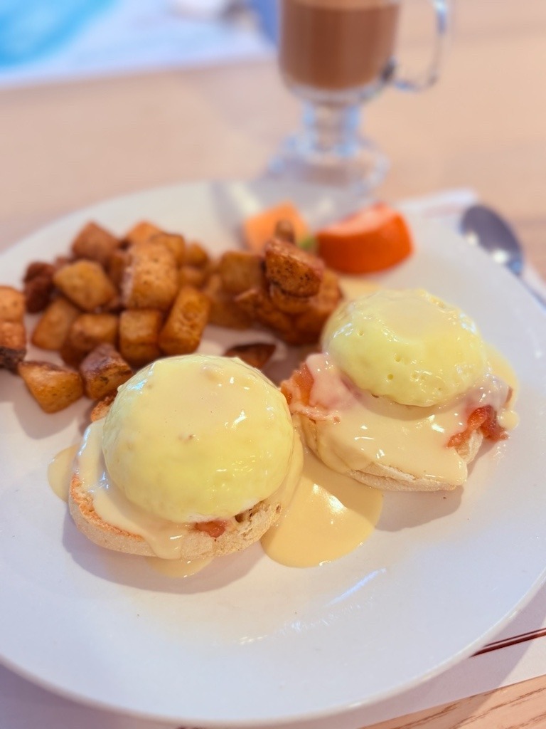 Eggs Benedict with home fries and hollandaise sauce at Coast restaurant in Cape Breton