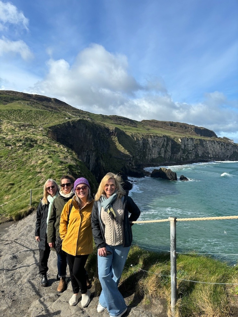 women at Carrick-a-rede on a women's travel trip