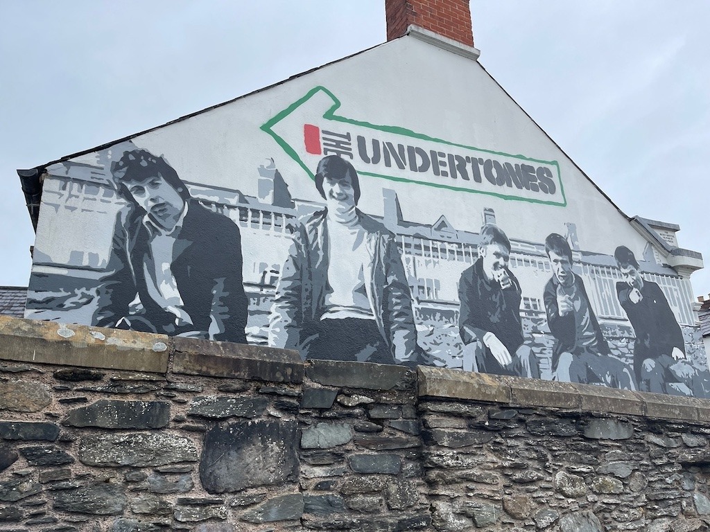 what to read watch and listen before visiting Ireland - The Undertones mural in Derry Ireland
