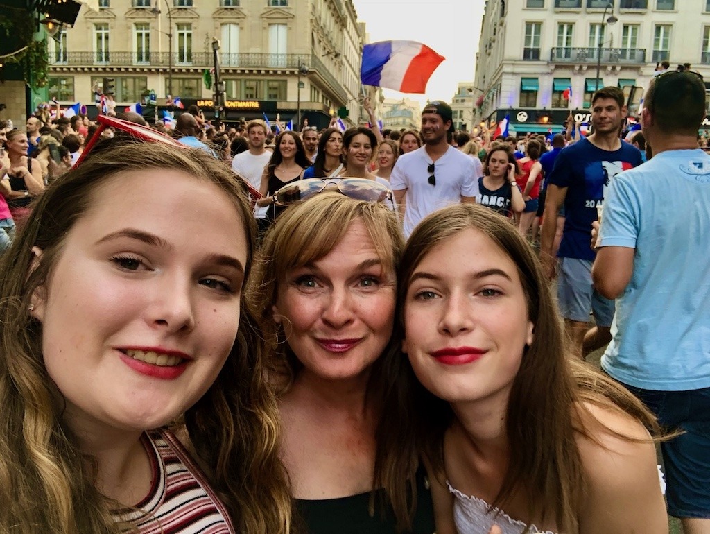 can travel heal a broken heart, Mother and two daughters celebrating France World Cup win in Paris streets 2018