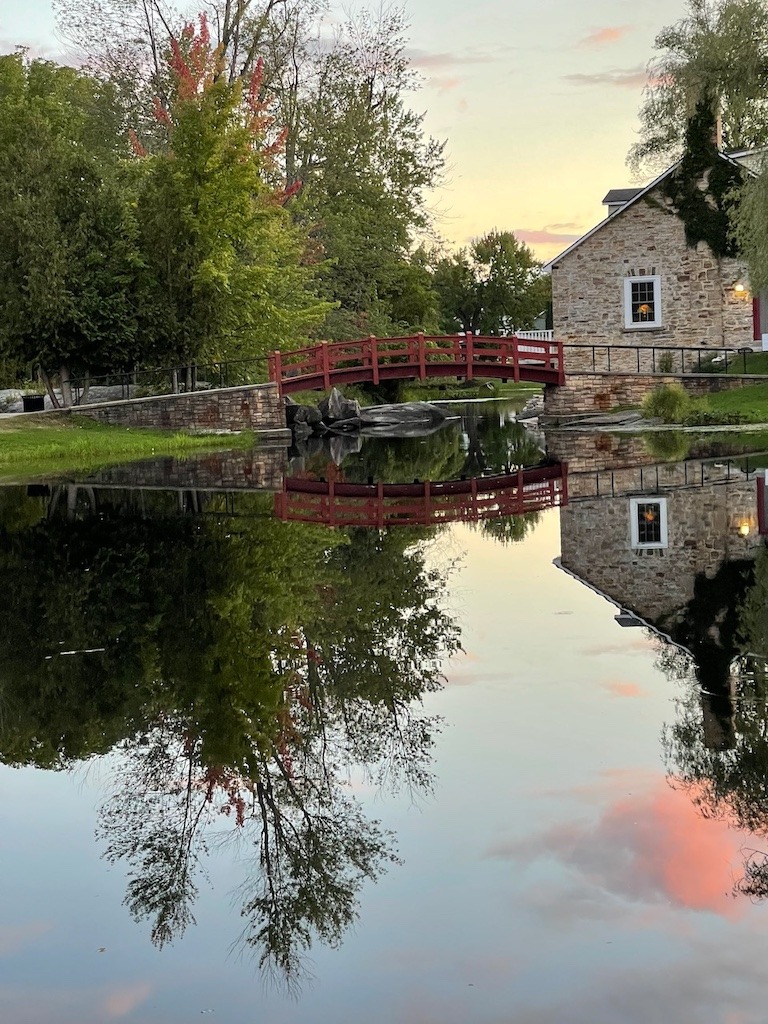 Red footbridge reflected in the Tay River at sunset 