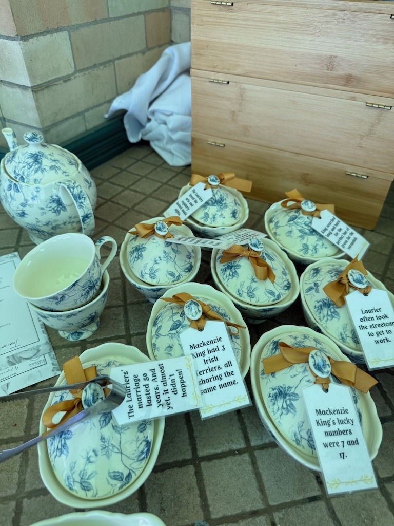 Blue toile china teacups with historical fact tags about Mackenzie King and Laurier House Ottawa