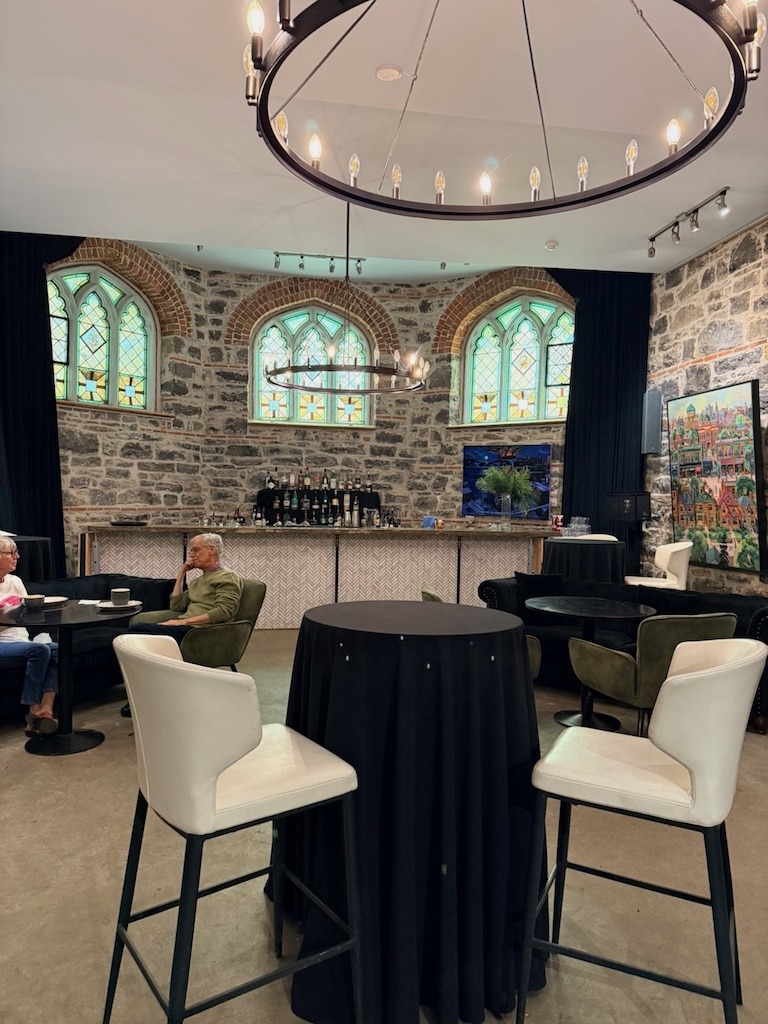 Working Title Kitchen bar area with Gothic arch stained glass windows and original stone walls Ottawa