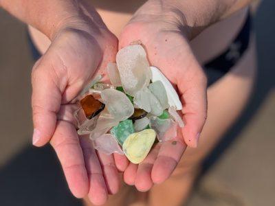 Sea glass Cape Breton haul held over the shoreline at Florence Beach