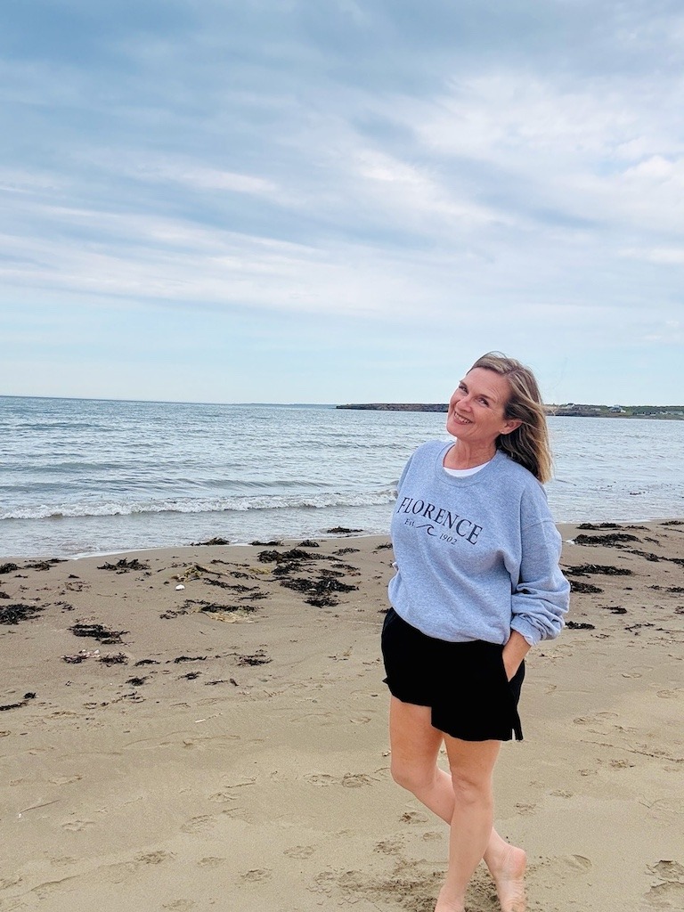 Standing on Florence Beach Cape Breton wearing local Florence sweatshirt
