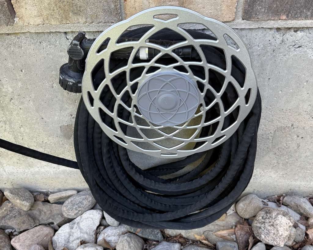 Hose reel installed on side of home